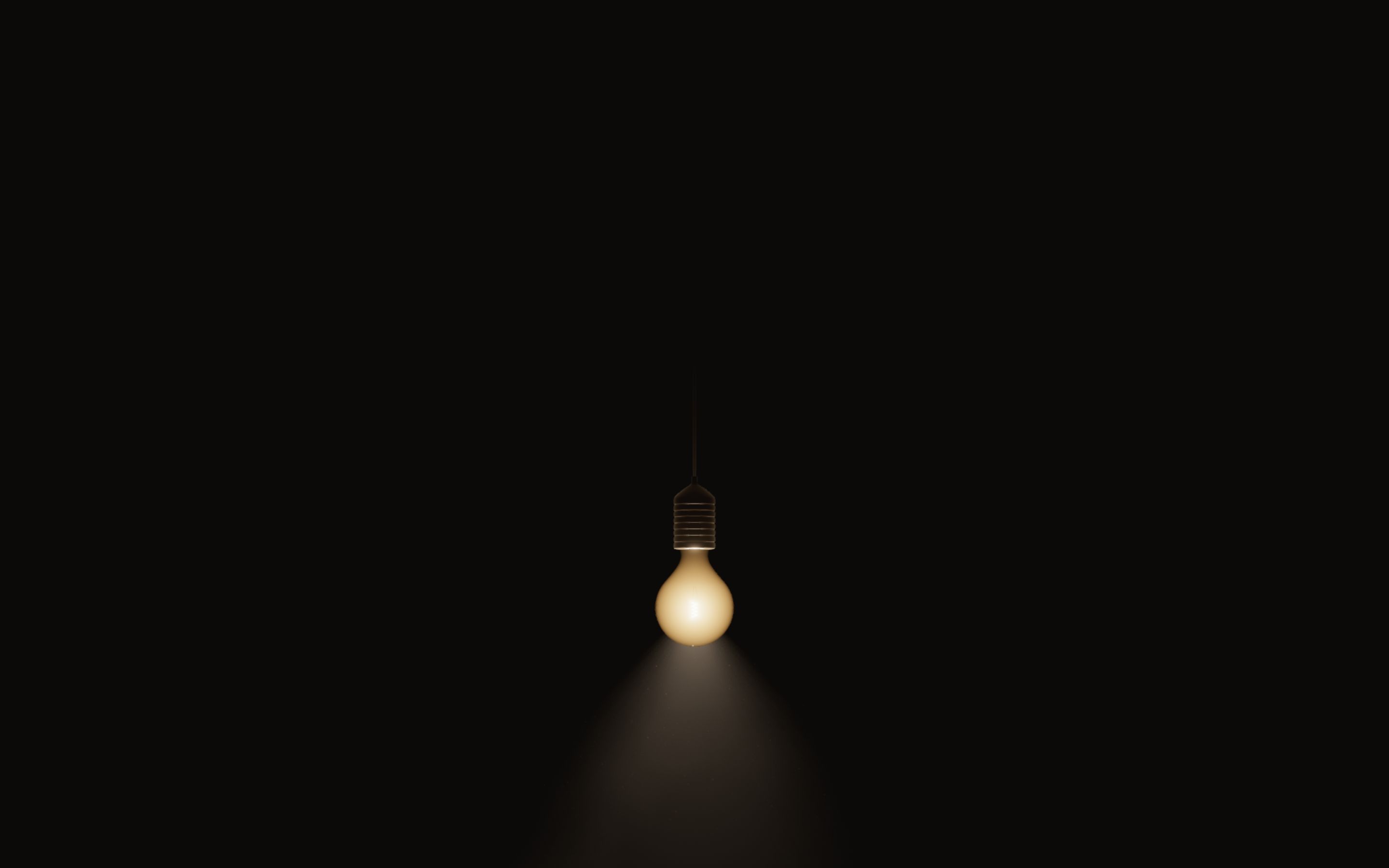 One small frosted bulb glowing low in a dark room, its cord rising out of the frame.